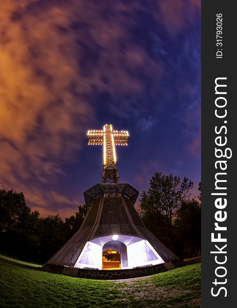 The lighted cross atop of the Mount-Royal in Montreal at night thru a fisheye lens. The lighted cross atop of the Mount-Royal in Montreal at night thru a fisheye lens