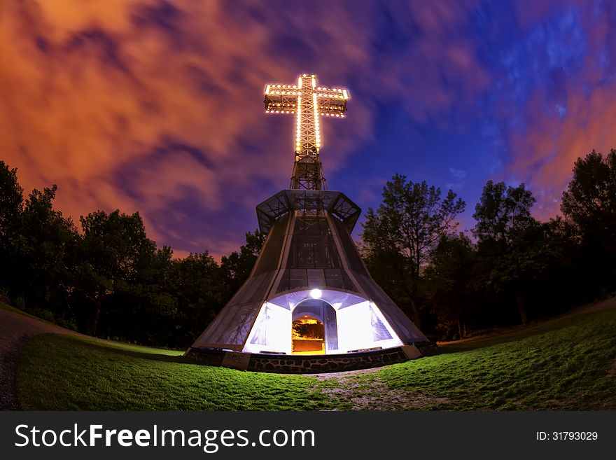 The lighted cross atop of the Mount-Royal in Montreal at night thru a fisheye lens. The lighted cross atop of the Mount-Royal in Montreal at night thru a fisheye lens