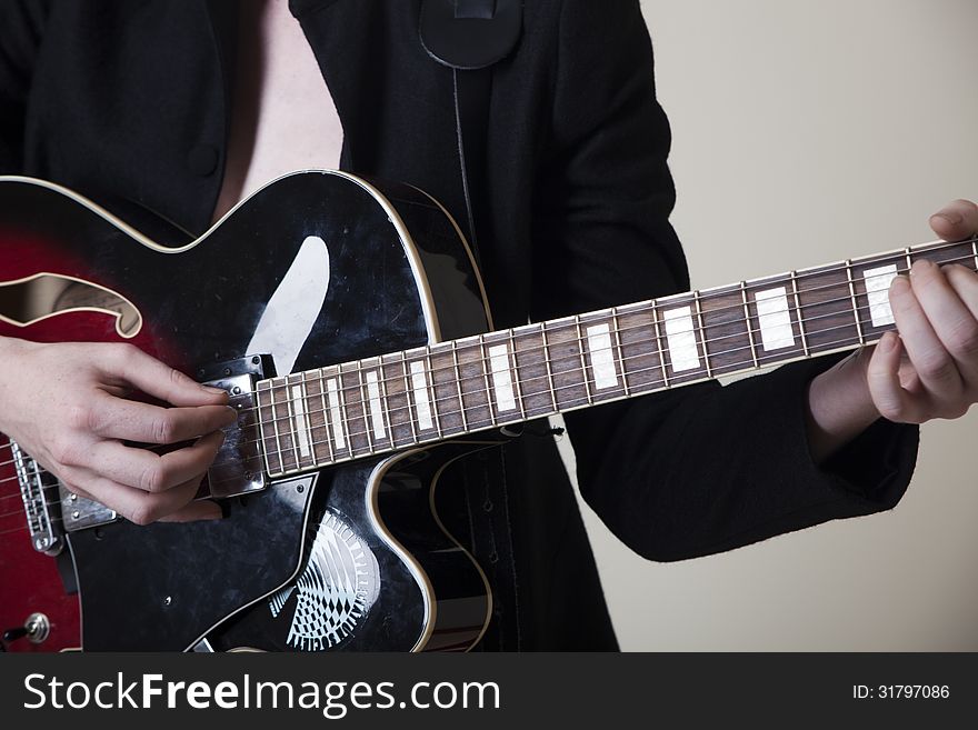 A young woman playing the guitar. A young woman playing the guitar