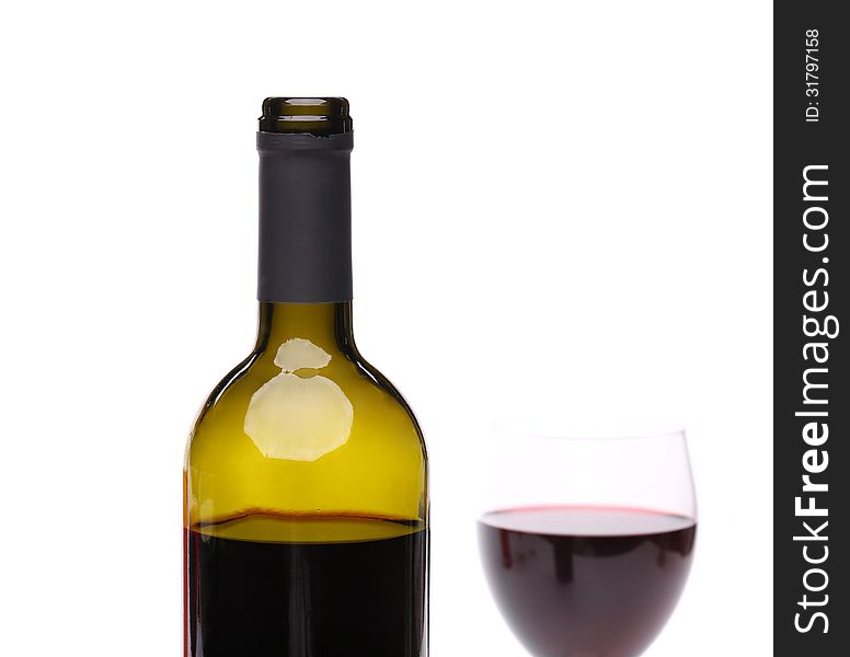 A bottle of red wine with a wine glass.