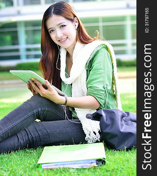 Beautiful young asian woman student learning with computer tablet. Beautiful young asian woman student learning with computer tablet