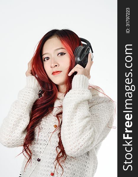 Asian woman with red color long hair listening. Asian woman with red color long hair listening