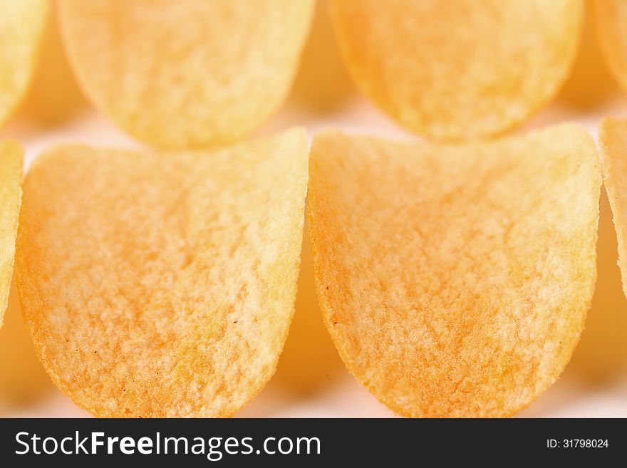 Close-up potato chips as a background. Close-up potato chips as a background