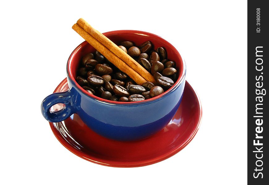 Coffee bens and a cinnamon stick with a colorful cup isolated on a white background. Coffee bens and a cinnamon stick with a colorful cup isolated on a white background
