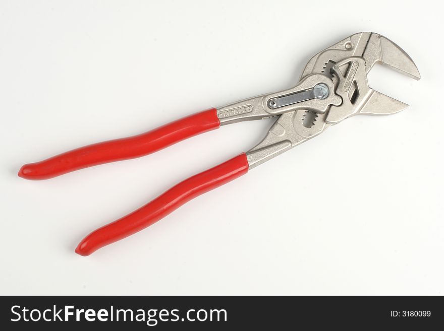 Red construction wrench on the white background
