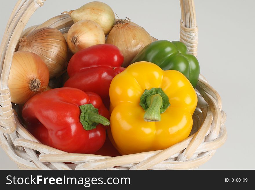 Basket with fresh peppers and onions. Basket with fresh peppers and onions