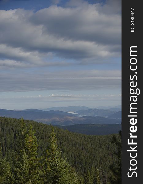 A mountain range with fog in the valleys