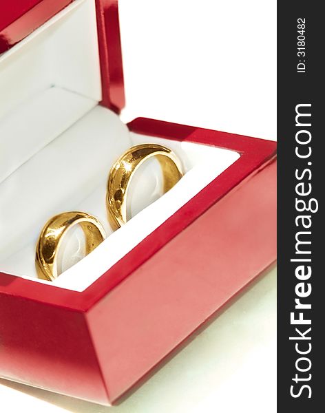 His and hers wedding rings in case. Studio shot, isolated over white background.