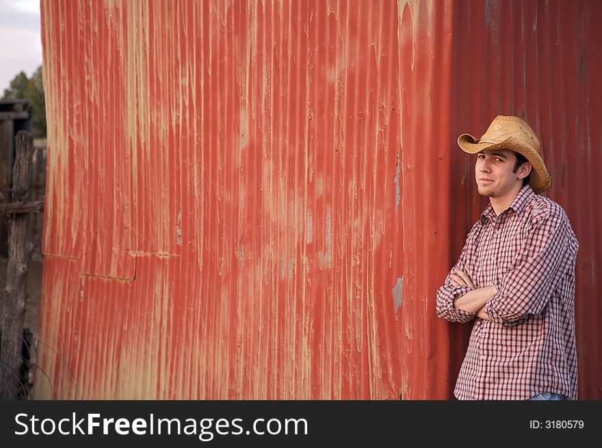 A young cowboy hanging out at the corral. A young cowboy hanging out at the corral