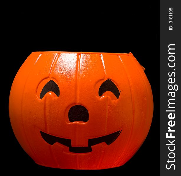 Plastic Jack-o-lantern, halloween decoration on black background. Plastic Jack-o-lantern, halloween decoration on black background