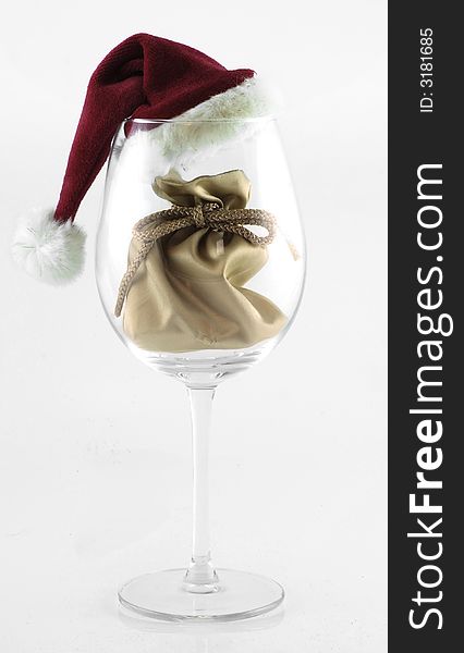 Easy to idolate christmas decoraion with santa's gift bag in the glass with santa's hat