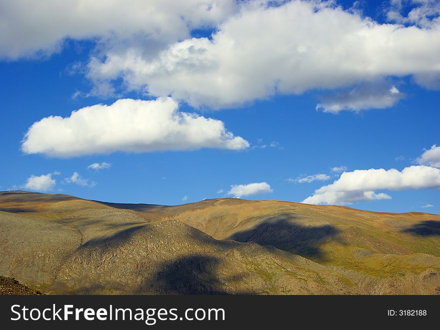 Mountain meadow with cloudscape and shadows abstract. Mountain meadow with cloudscape and shadows abstract