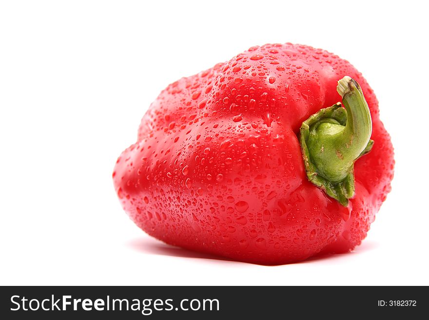 The Bulgarian red pepper, is covered by sparks of water, on a white background, pulse light. The Bulgarian red pepper, is covered by sparks of water, on a white background, pulse light.