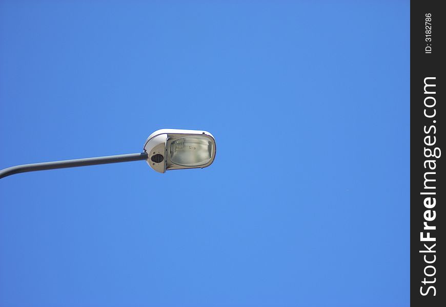 A street-lamp under a clear blue sky in summer. A street-lamp under a clear blue sky in summer