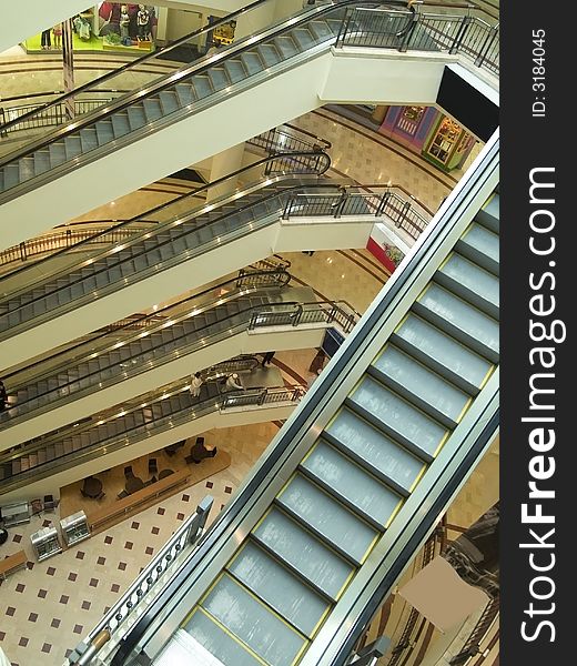 Escalators on several floors of a shopping mall. Escalators on several floors of a shopping mall
