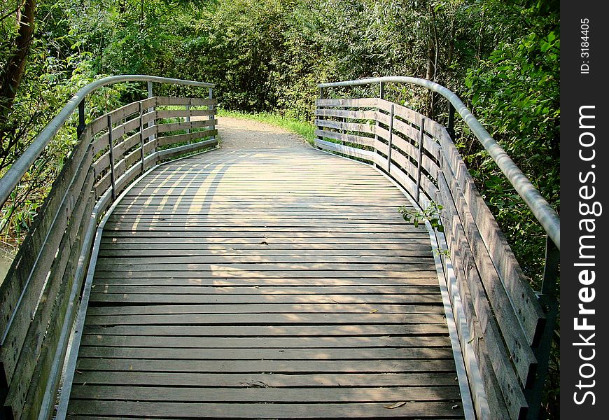 A particular bridge on a nice pond in a park. A particular bridge on a nice pond in a park