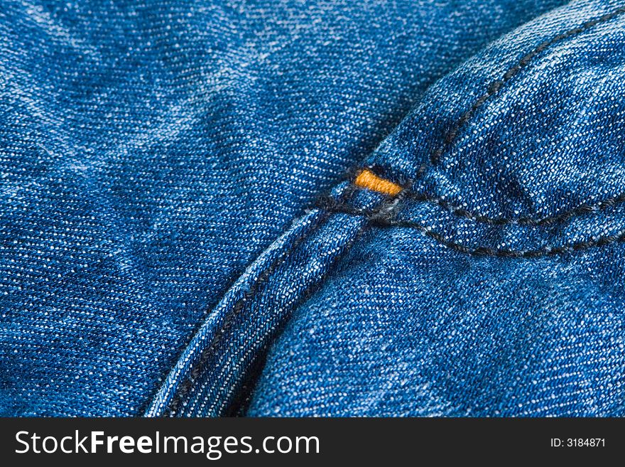 Textured background of dark denim jeans.