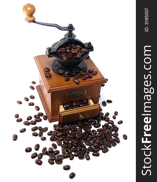 Coffee grinder and large coffee beans on a white background.