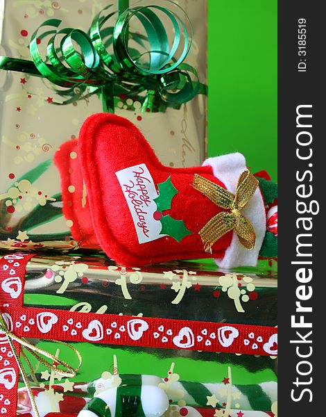 Christmas gifts with a miniature stocking lying ontop of it. Christmas gifts with a miniature stocking lying ontop of it