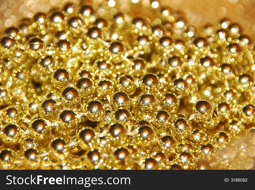 Golden beads; could be used in backgrounds. Golden beads; could be used in backgrounds