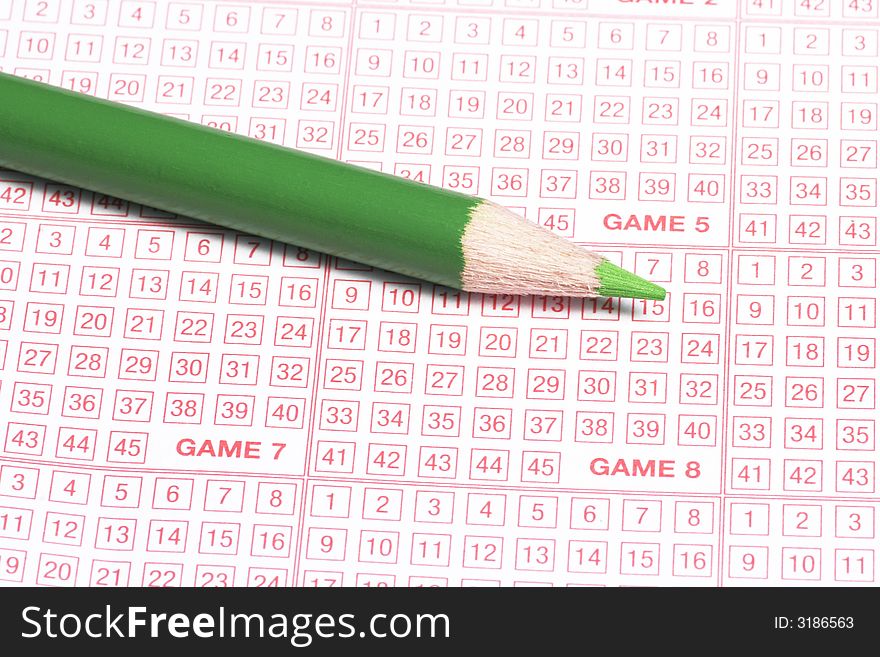 Close-Up Of Lottery Ticket And Green Pencil