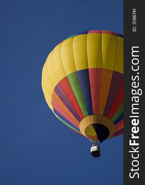 Colorful hot air balloon in deep blue sky