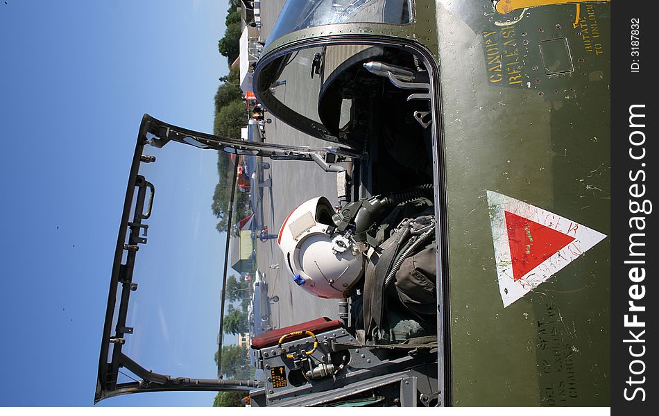 Open cockpit of a jet fighter, with a dummy placed inside.