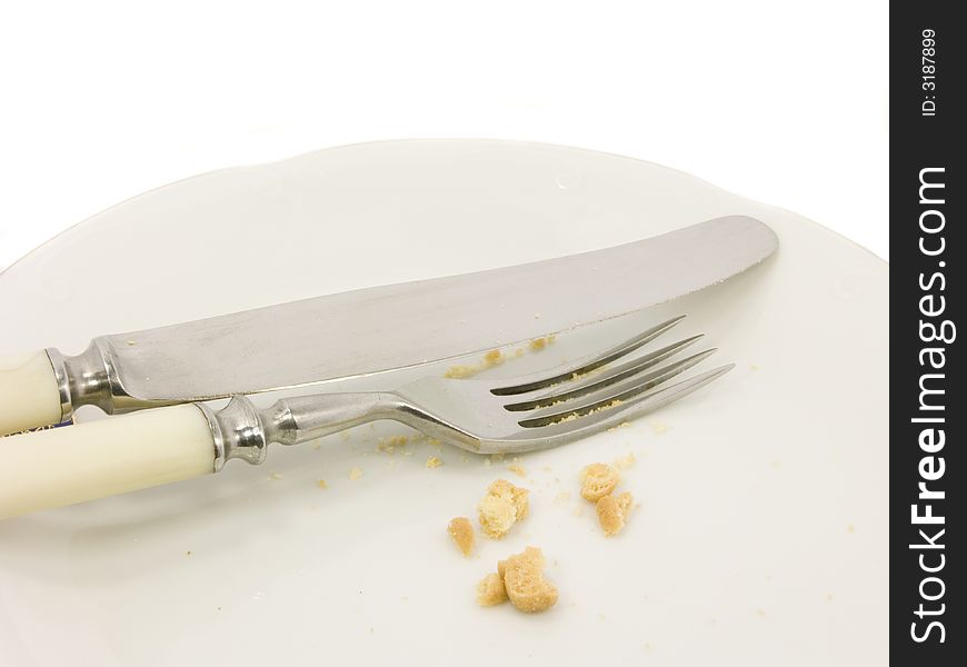 Fork and knife on white plate