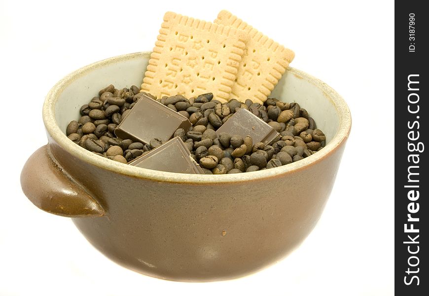 Brown bowl with coffee beans, chocolate and biscuit