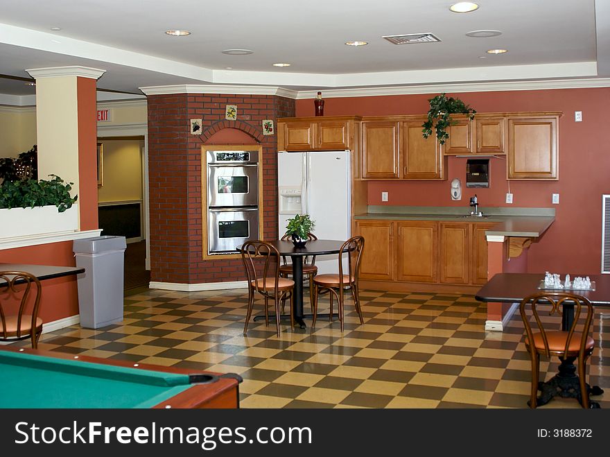 Bistro style room with checkered floor, tables, oven, sink, counter