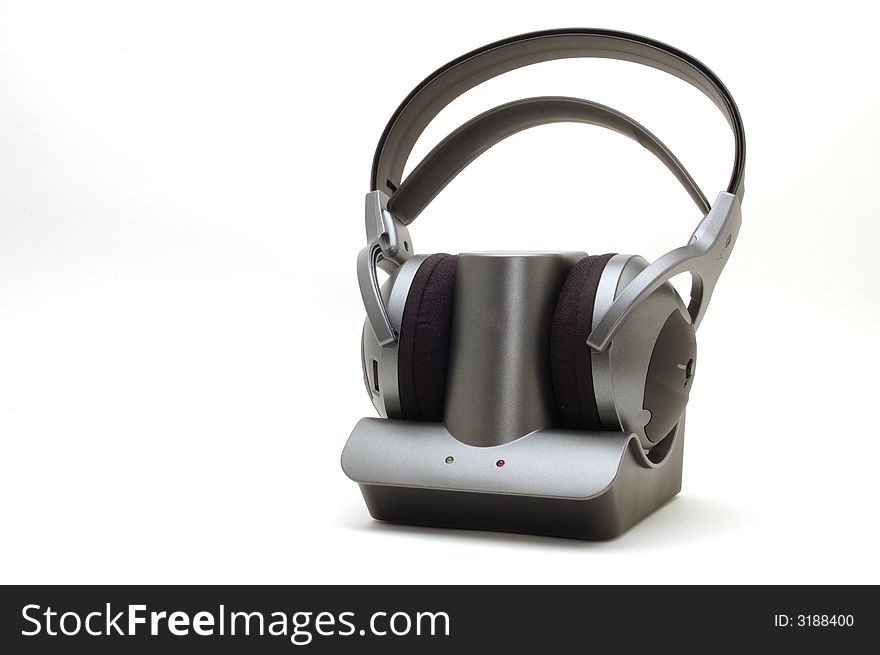 An image of cordless headphone sitting on thier base unit on white background. An image of cordless headphone sitting on thier base unit on white background