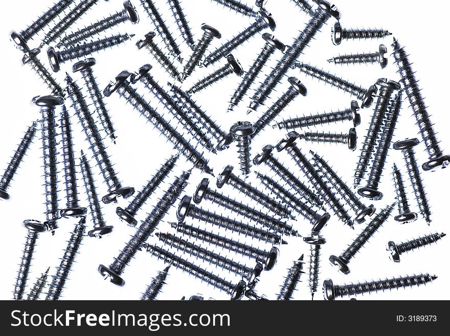 Many Spiral Metal Screws On A White Background