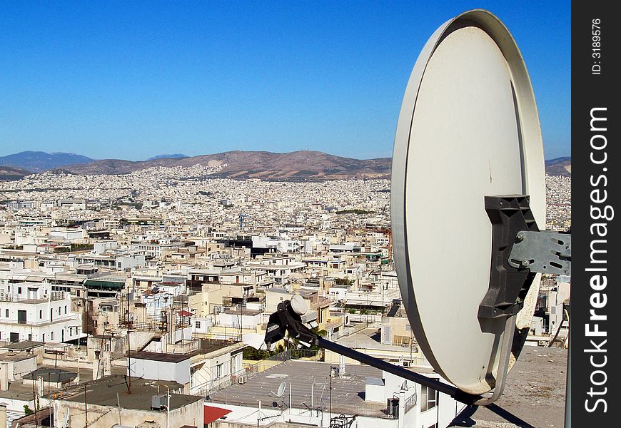 Satellite dish against city landscape. Satellite dish against city landscape