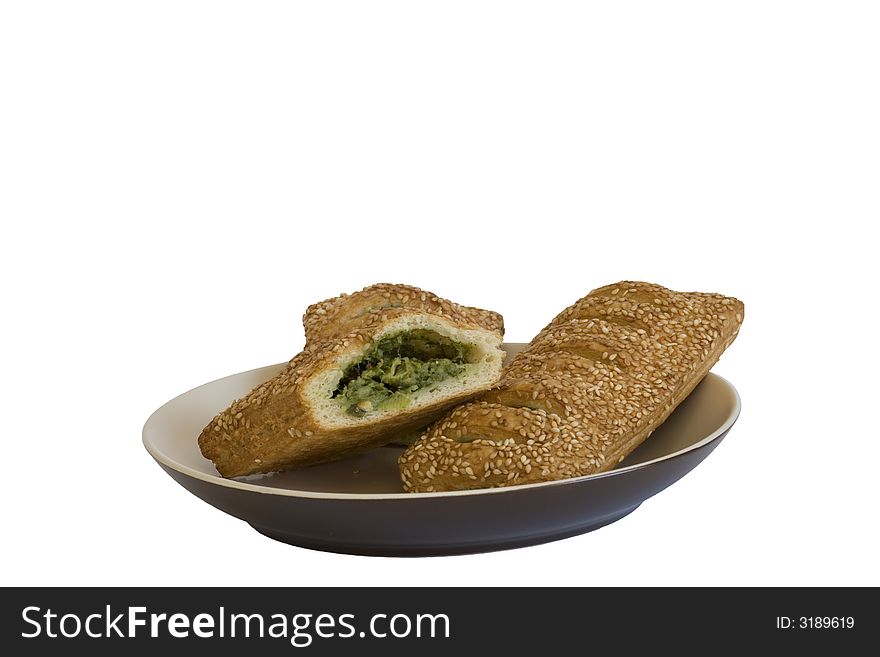 White bread with spinach and sesame on a plate. White bread with spinach and sesame on a plate.