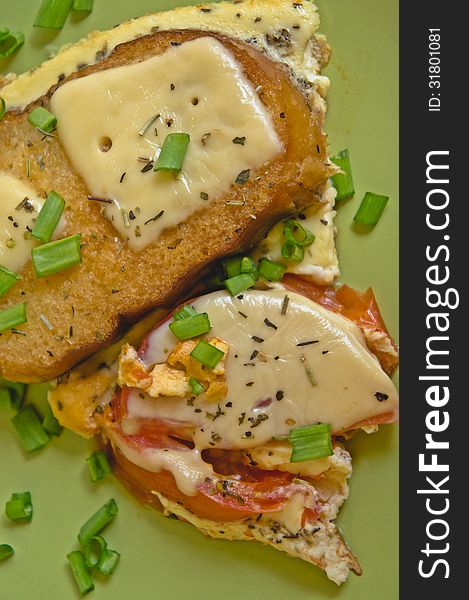 Scrambled eggs with tomato and toast with cheese with herbs and green onions