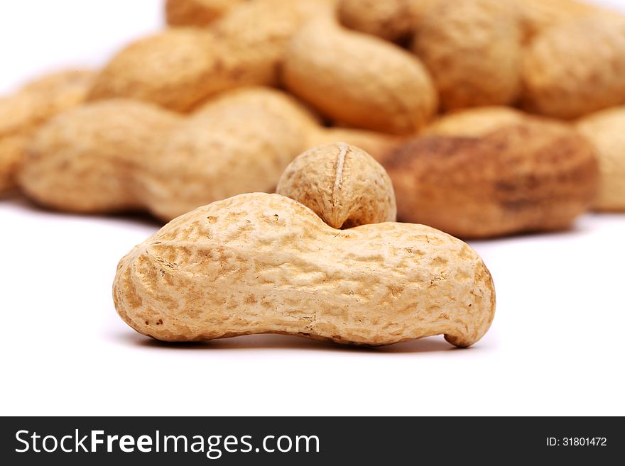 Dried peanuts in closeup on a white background