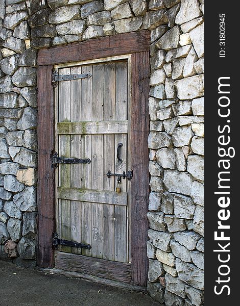 Very old wood door in a stone wall. Very old wood door in a stone wall