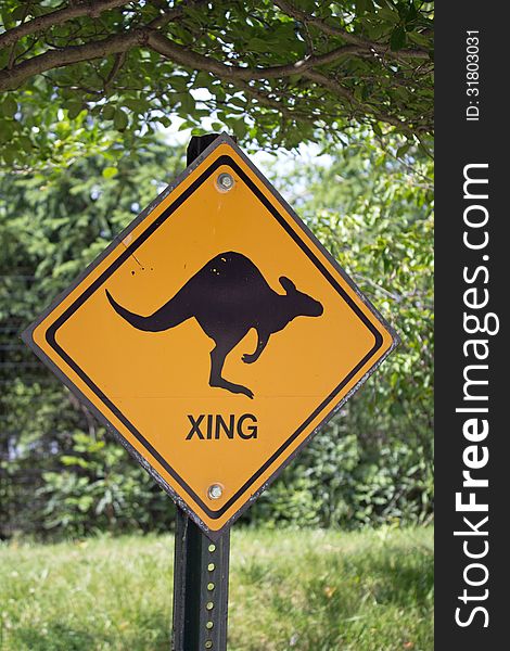 Orange kangaroo crossing warning sign