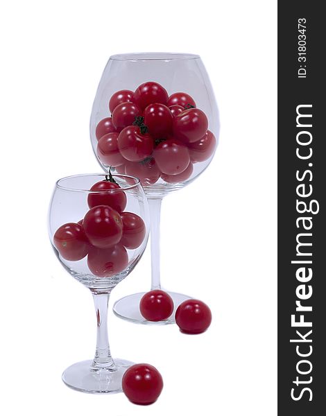 Cherry tomatoes in two glass wine glasses. Cherry tomatoes in two glass wine glasses