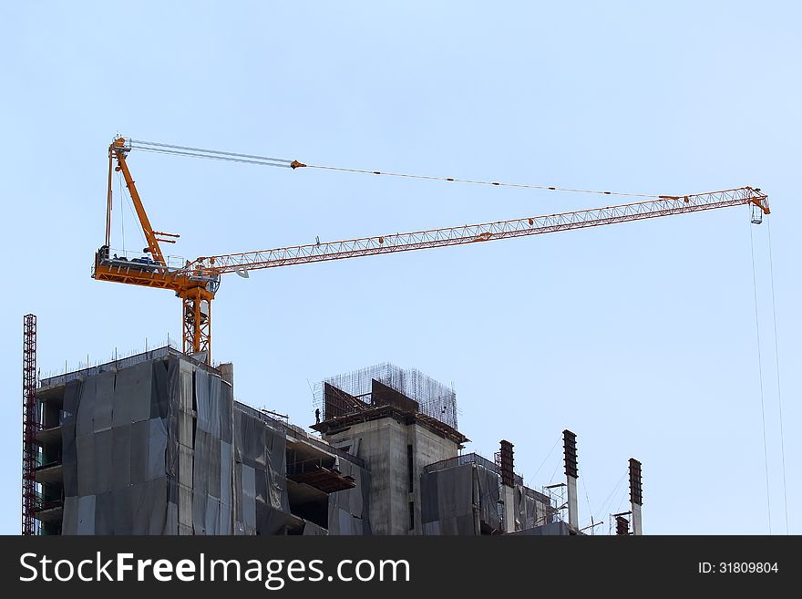 Construction site with crane on sky background