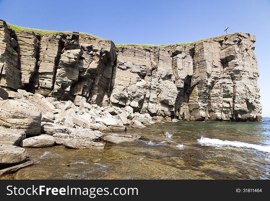 The sea and rocks under beams of a bright sun