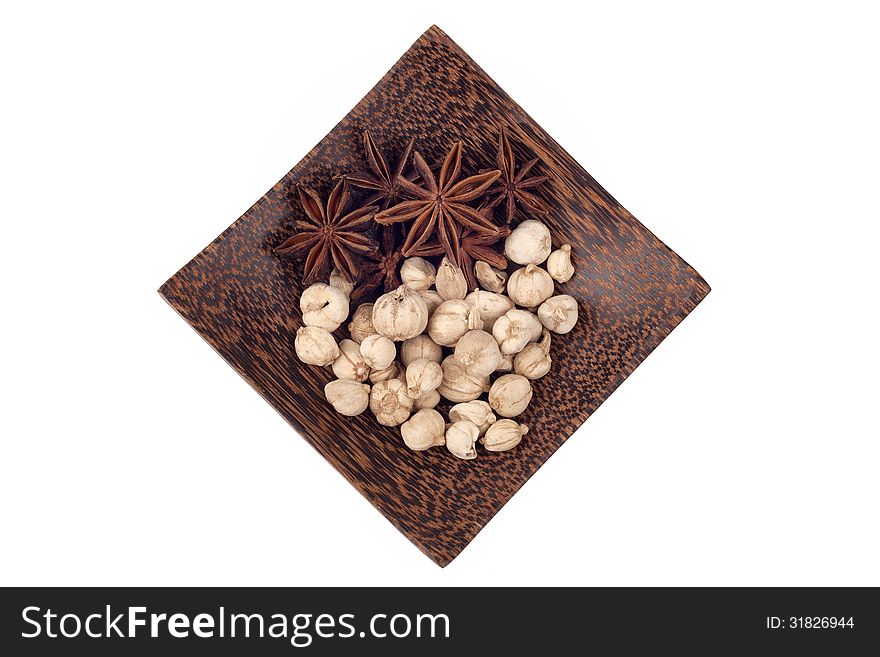 Star anise and camphor seeds on wood tray isolated on white background. Star anise and camphor seeds on wood tray isolated on white background