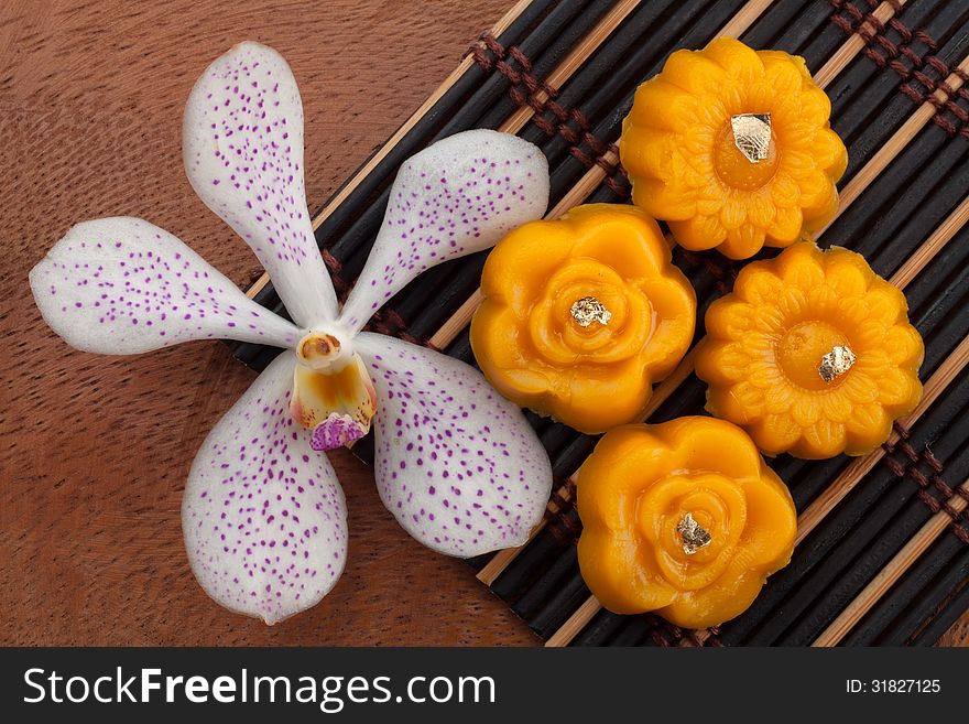 Thai sweetmeat made of yolk with orchid flower on wood tray. Thai sweetmeat made of yolk with orchid flower on wood tray