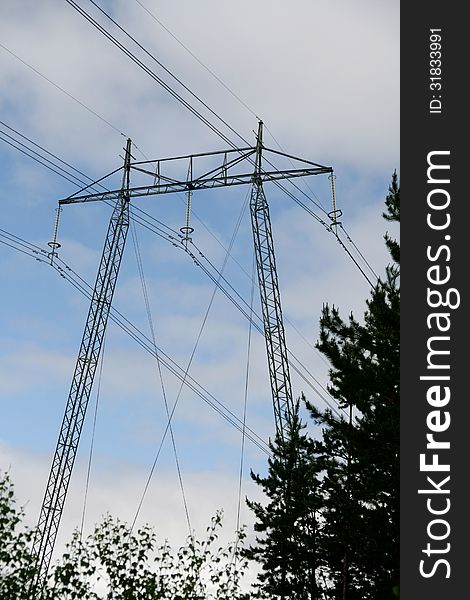 High voltage mast against the sky