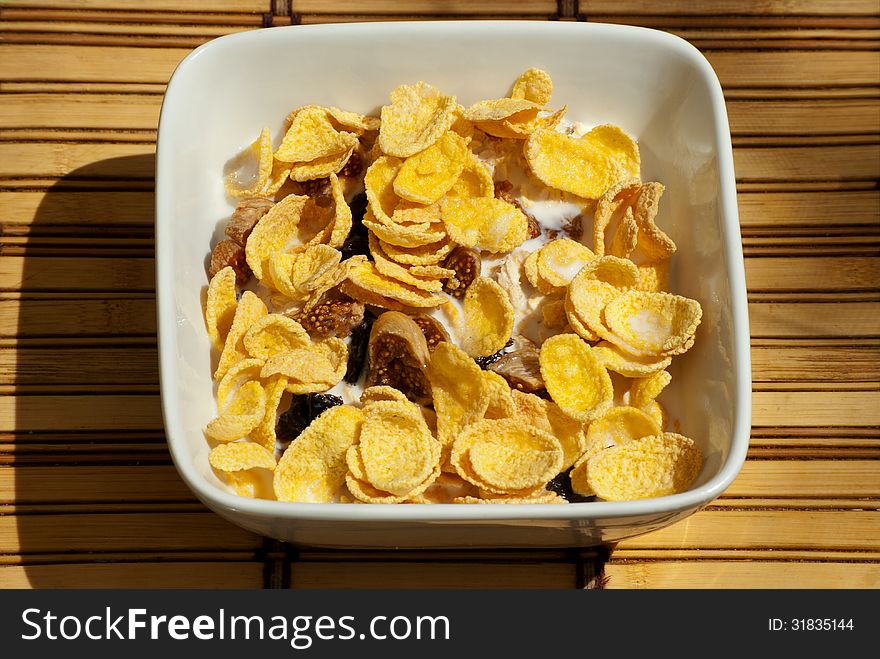 Bowl of oatmeal with cereal, prunes and milk