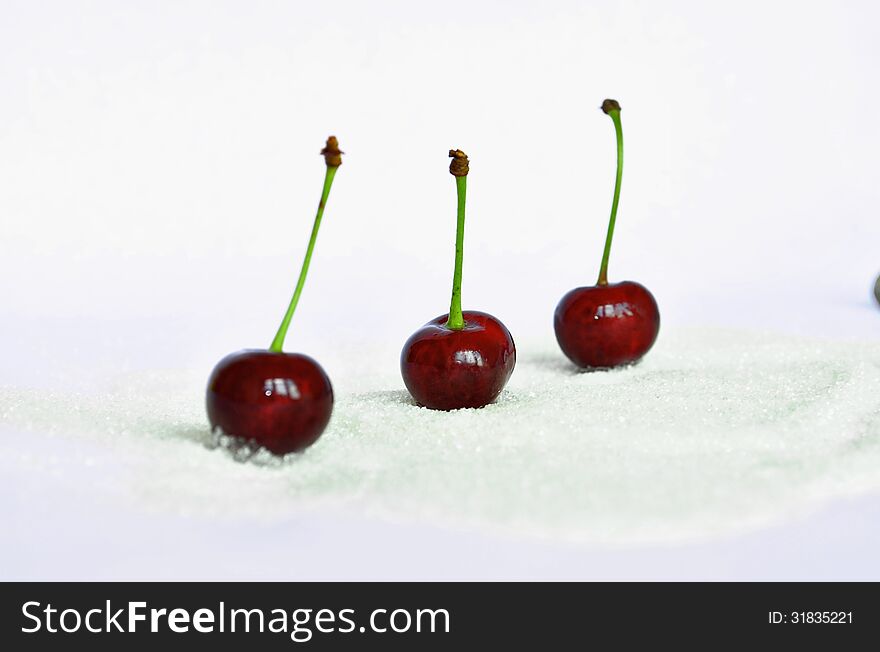 Three sweet cherries on a white background. Three sweet cherries on a white background