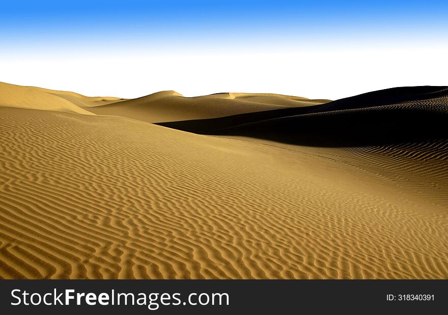 Tranquil And Serene: Exploring The Vast And Undulating Golden Sand Dunes At Twilight In The Arid Desert Landscape