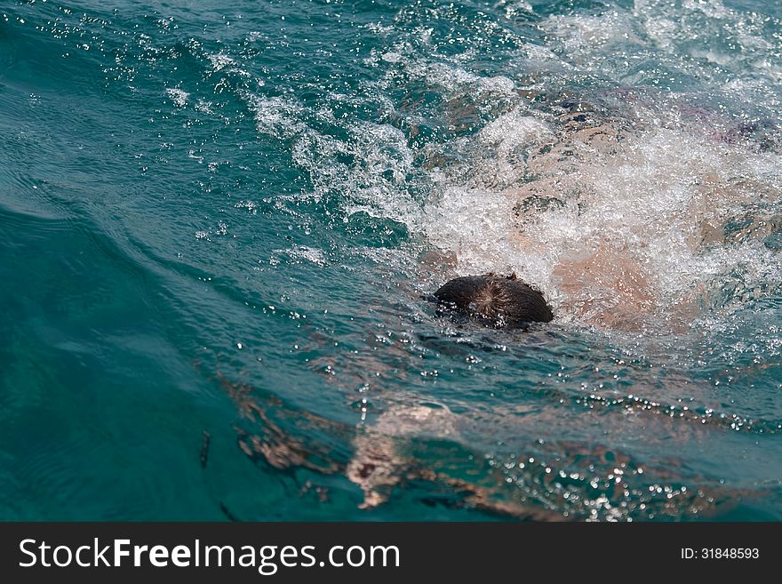 Man is swimming in sea under water