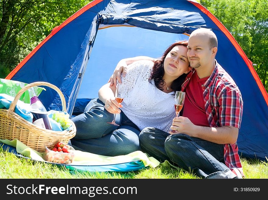 Happy young couple is relaxing on a camping. Happy young couple is relaxing on a camping