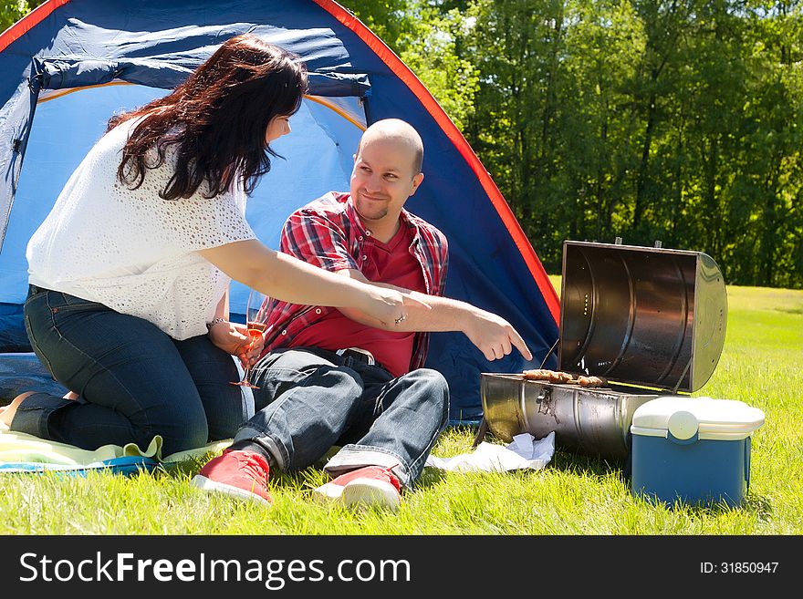 Happy young couple is relaxing on a camping. Happy young couple is relaxing on a camping